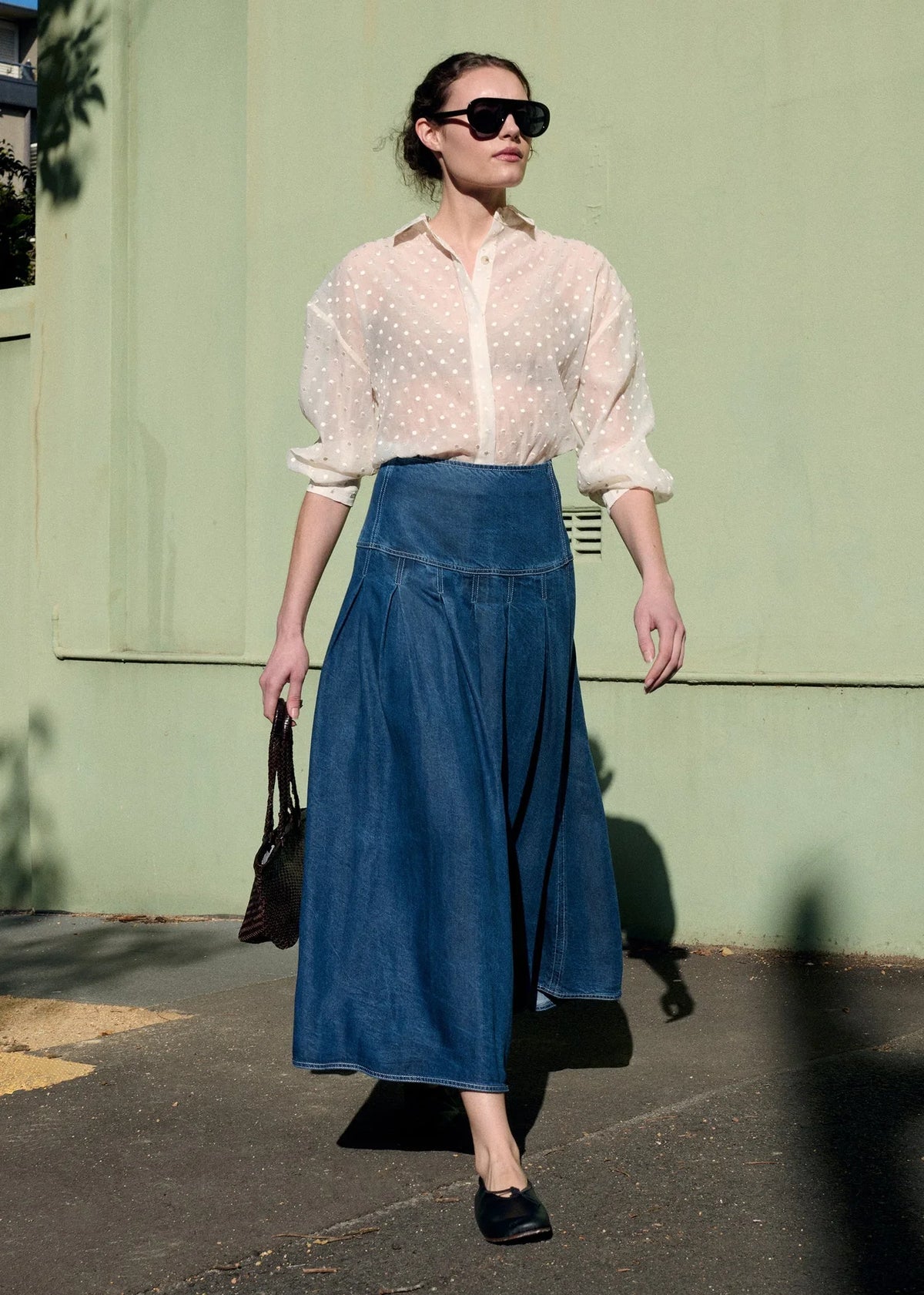 Model wearing STAPLE THE LABEL Etoile Oversized Shirt in Cream Spot with a denim midi skirt.