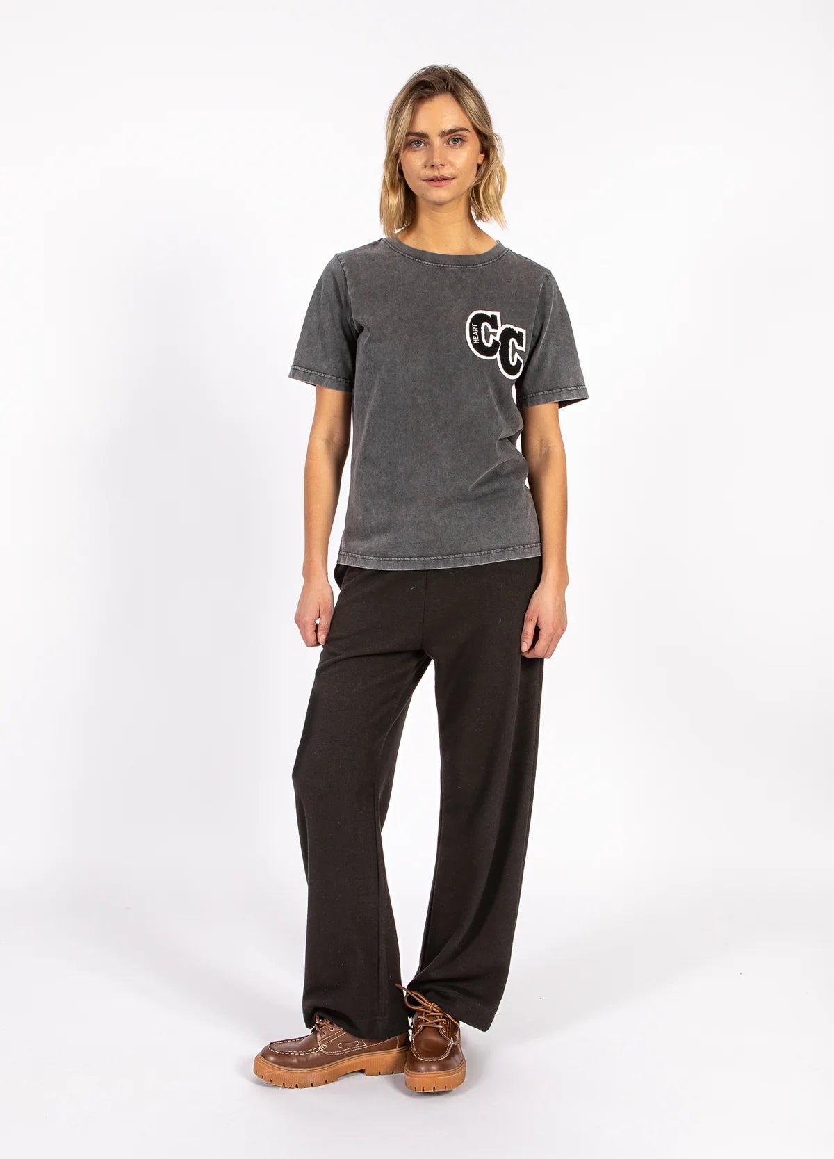 Woman modeling casual grey CC graphic t-shirt and black pants, The Tartan Fox fashion