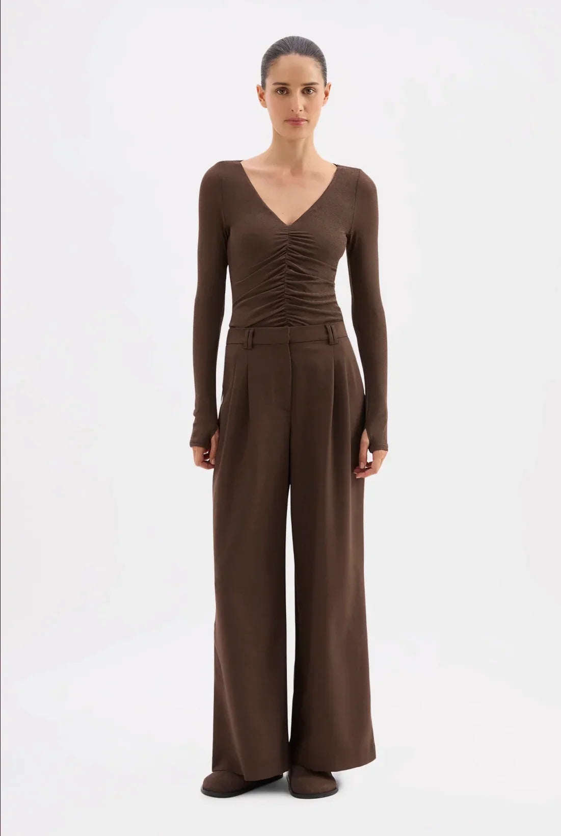 Brown long sleeve V-neck top with ruched detail paired with wide-leg trousers for women's fashion