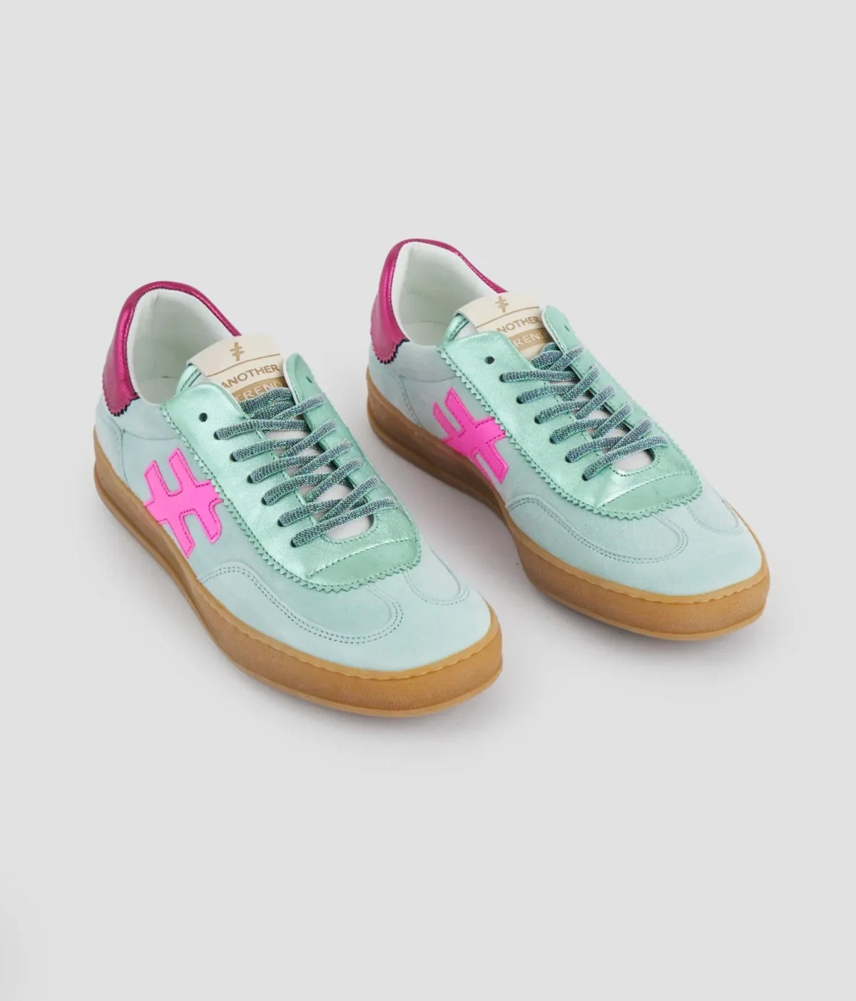 Light blue sneakers with pink accents and tan soles