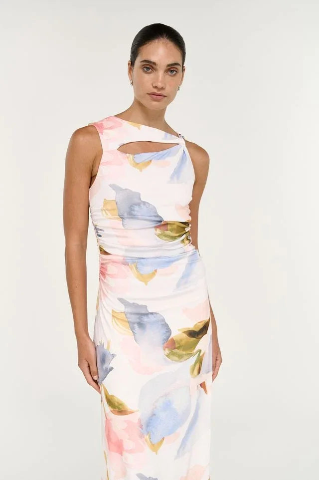 Woman wearing a watercolor print cutout midi dress with pink and blue tones