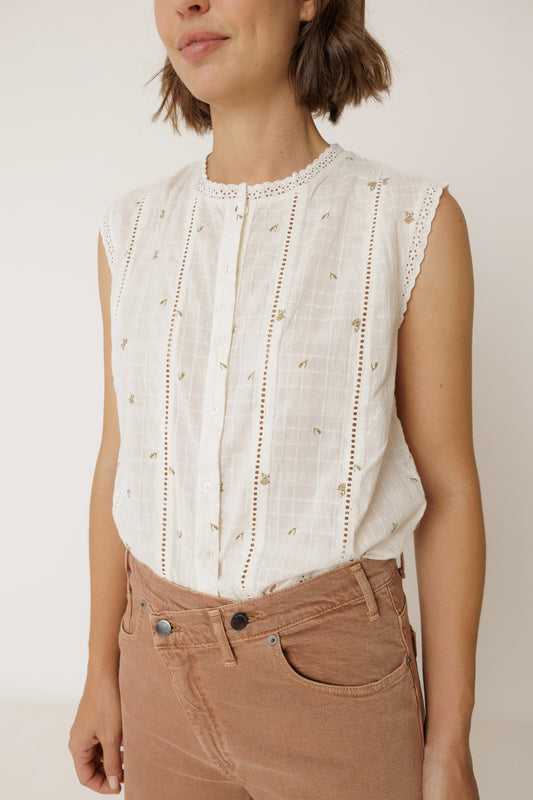 Woman wearing an INDI & COLD Stamp Print Sleeveless Shirt with brown corduroy trousers