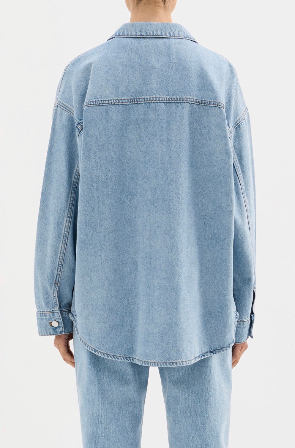 Light blue denim shirt and matching jeans, oversized fit, back view