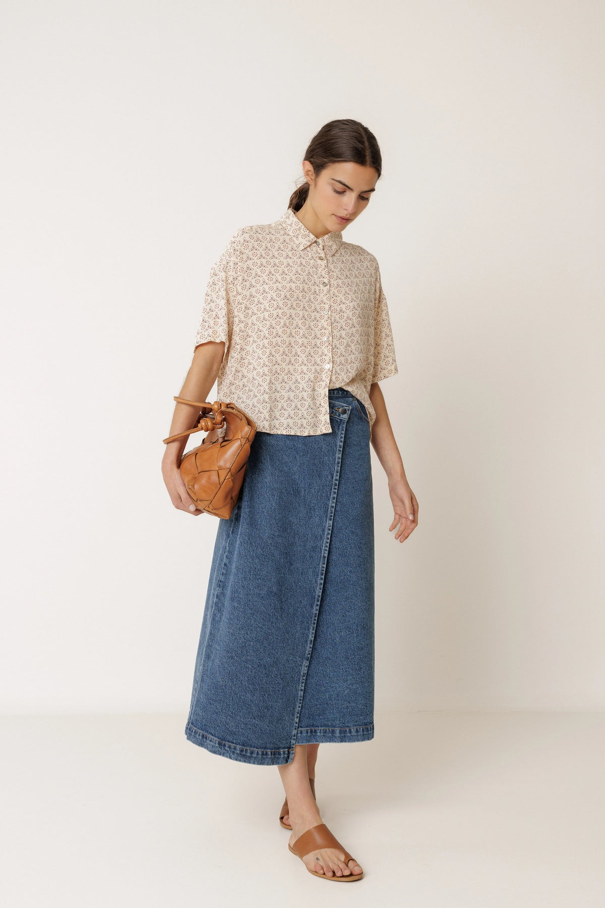 Woman wearing INDI & COLD Oversized Block Print Shirt in Crudo and a blue denim skirt