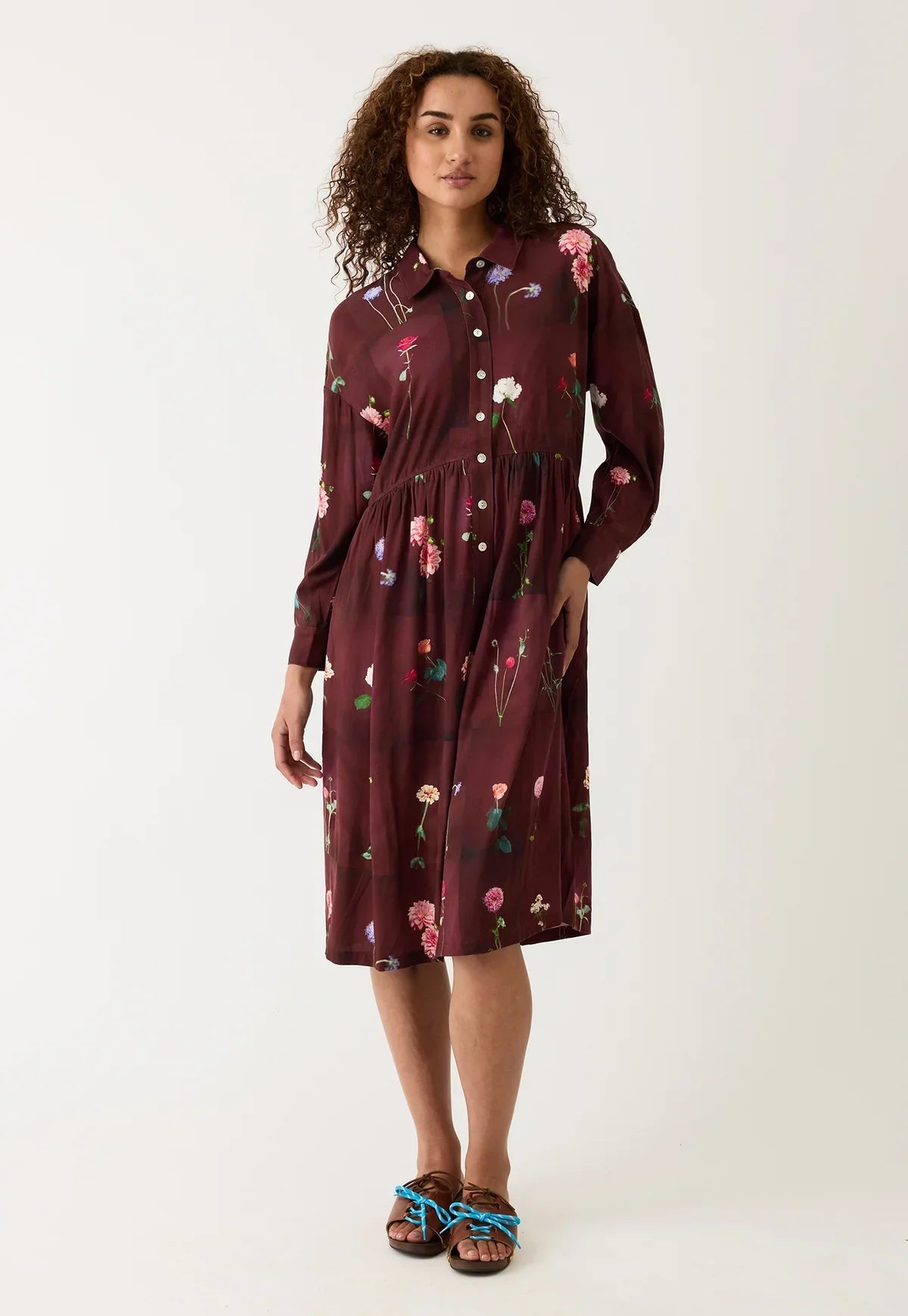 Burgundy floral print shirt dress with long sleeves and button front, paired with sandals