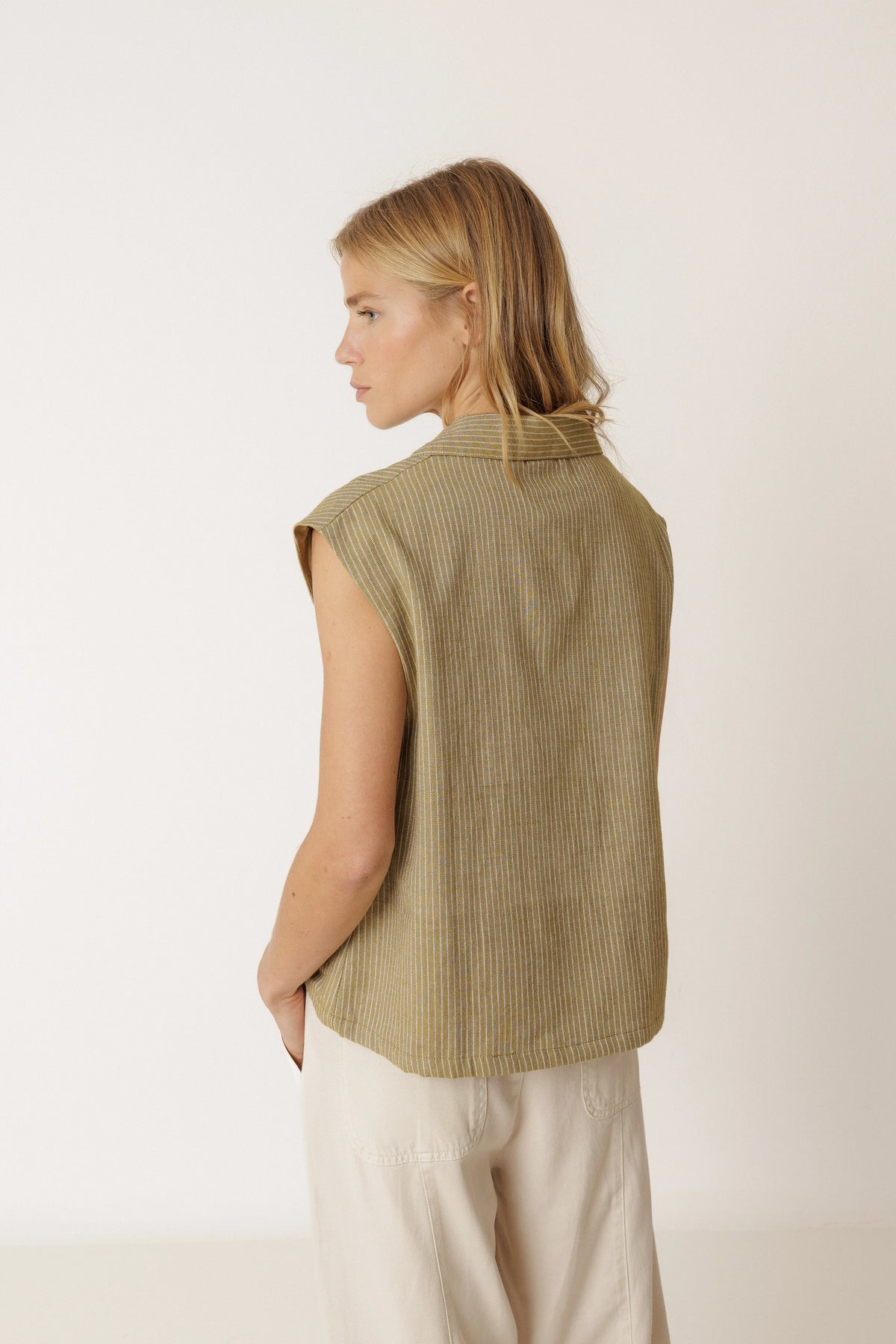Woman wearing the INDI & COLD Pinstripe Tailored Vest in Khaki from the back.