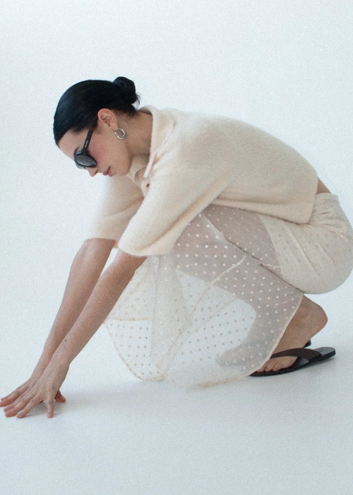 Woman wearing a STAPLE THE LABEL Etoile Layered Midi Skirt in Cream Spot and a fuzzy sweater.