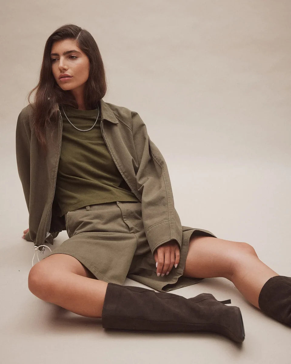 Woman wearing Nobody Denim Jean Tee in Olive with a matching jacket and shorts.