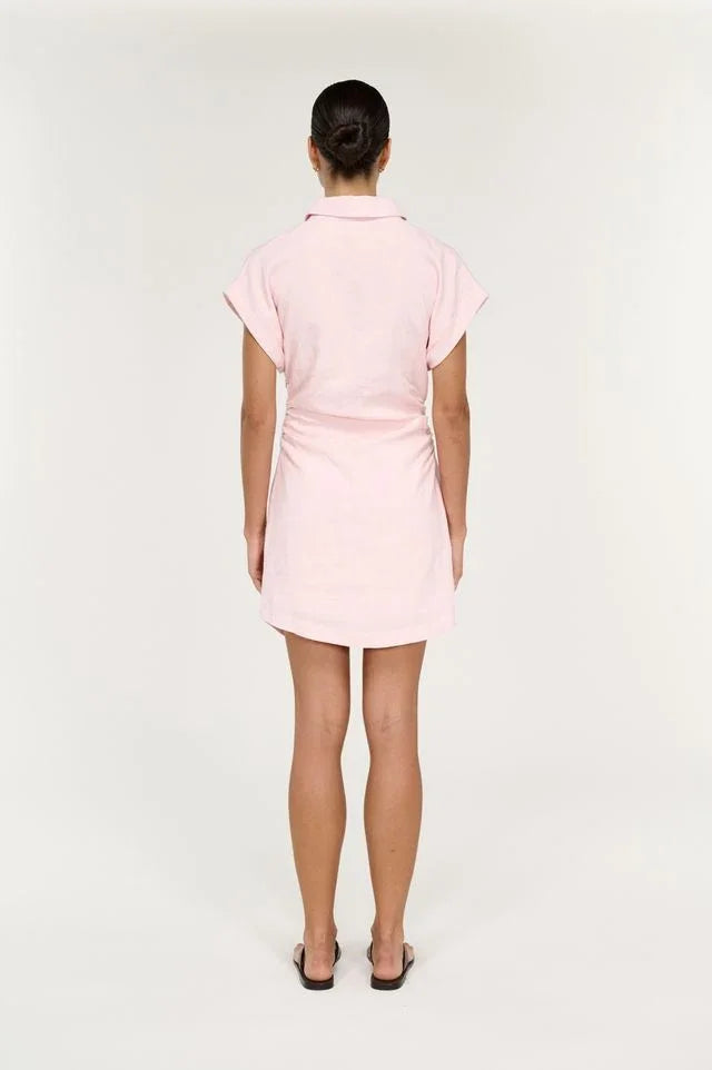 Back view of a woman wearing the STAPLE THE LABEL Avella Mini Dress in Rose Pink