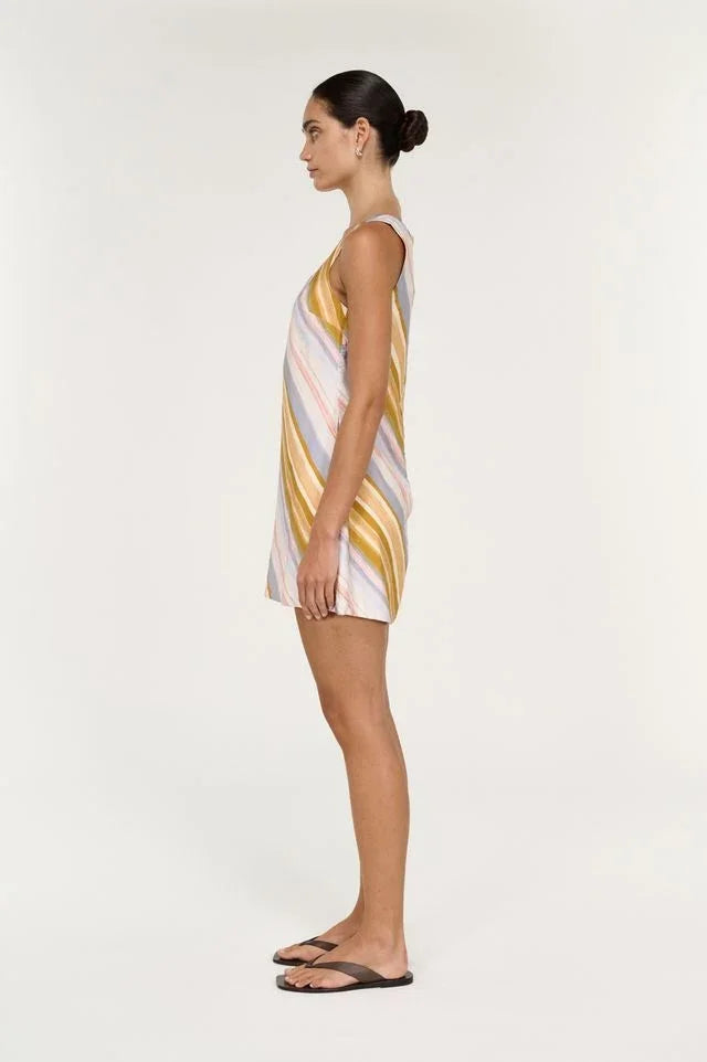 Side view of a woman wearing the STAPLE THE LABEL Veda Mini Dress in Stripe.