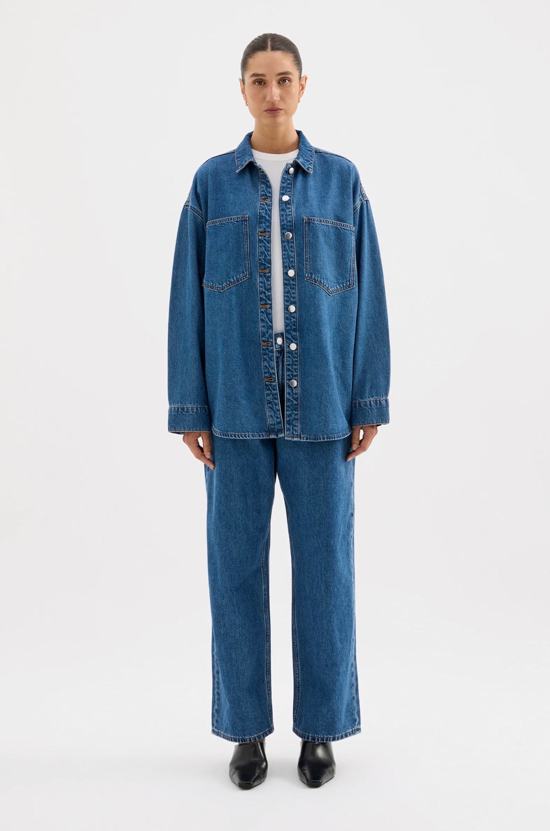 Women's denim shirt and wide-leg jeans outfit with black boots