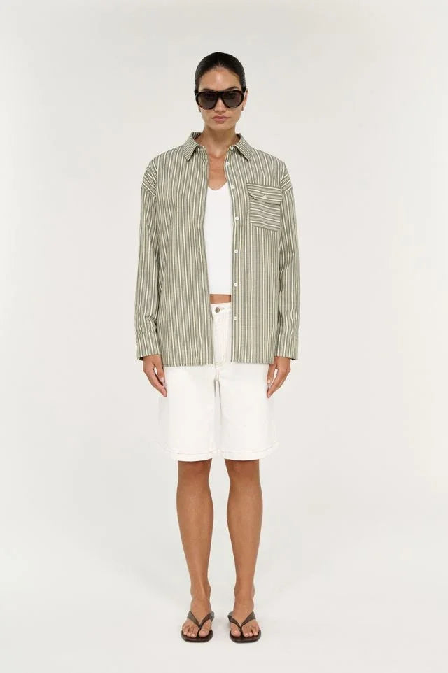 Model wearing STAPLE THE LABEL Lisara Oversized Shirt in khaki and white stripe with white shorts.