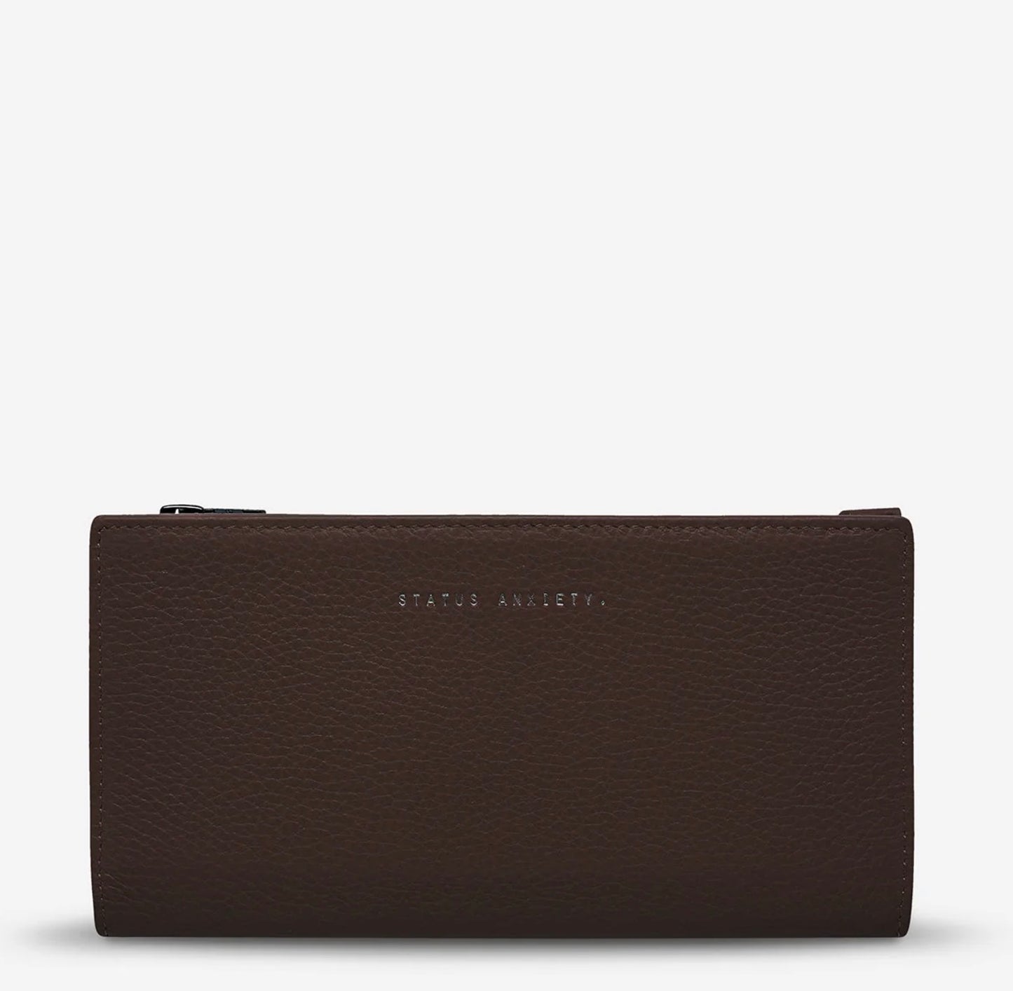 Brown leather wallet with 'STATUS ANXIETY.' embossing, minimalist design for everyday use