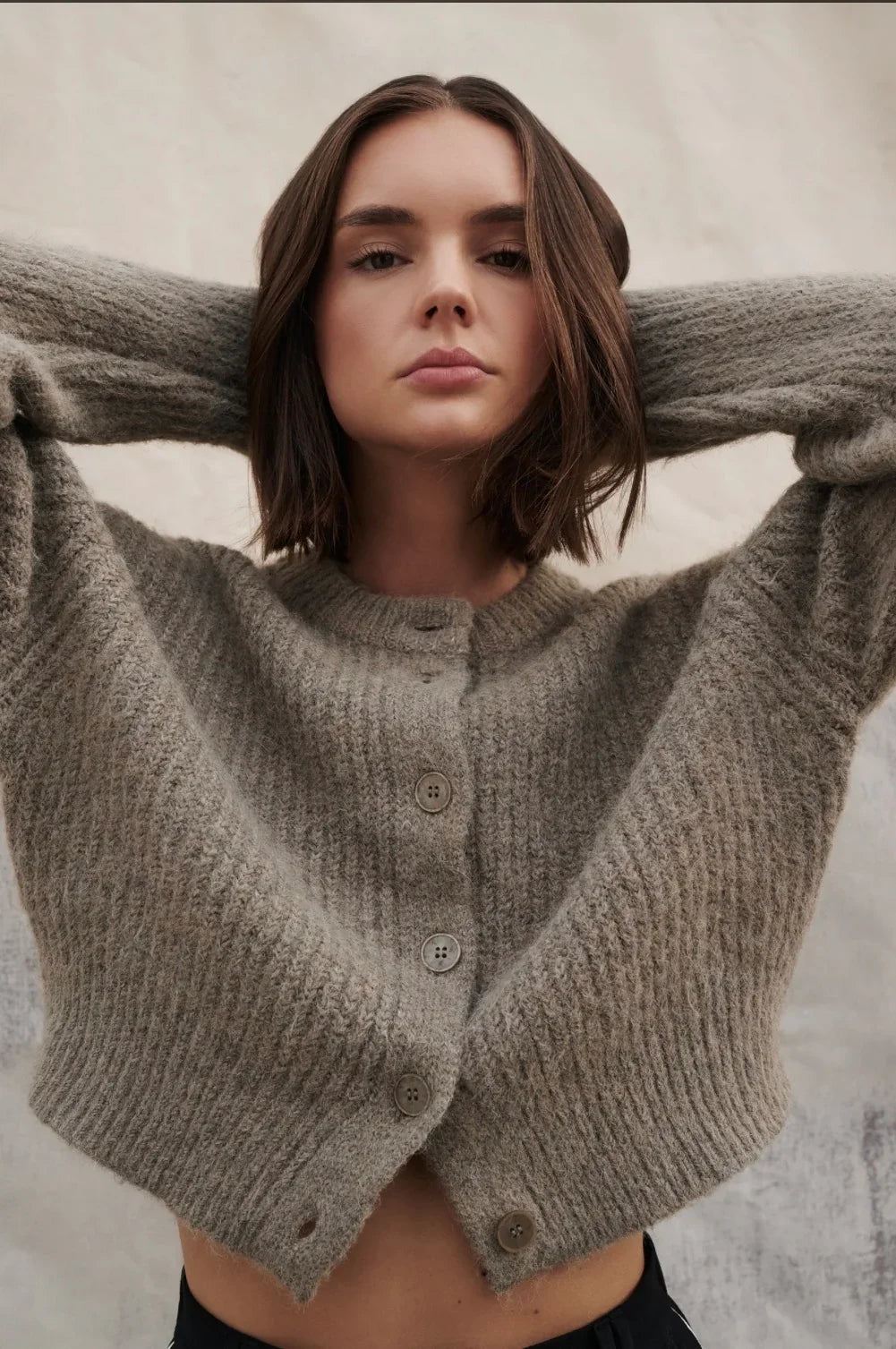 Woman modeling cozy grey button-front cropped cardigan sweater, stylish women's fashion