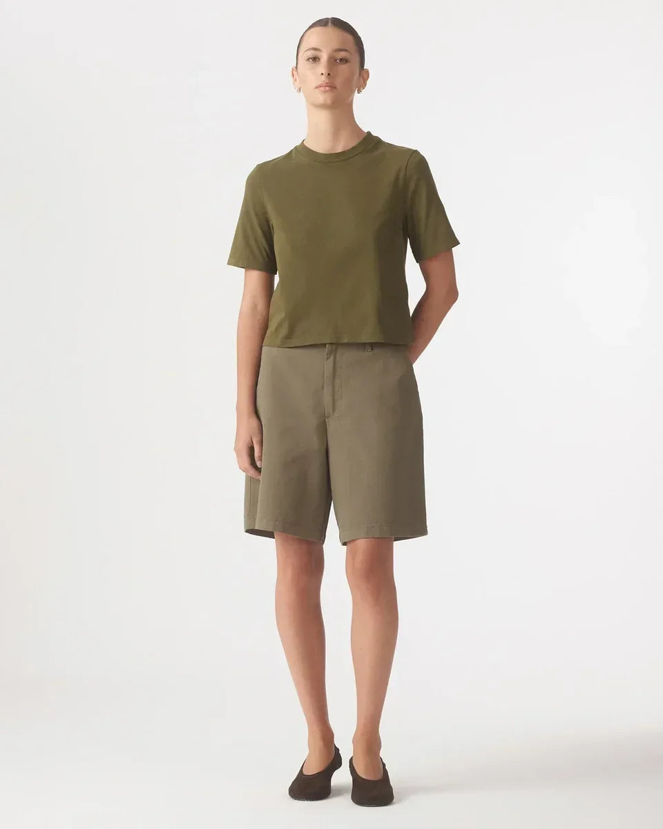 Woman wearing a Nobody Denim Jean Tee in Olive and matching olive shorts.