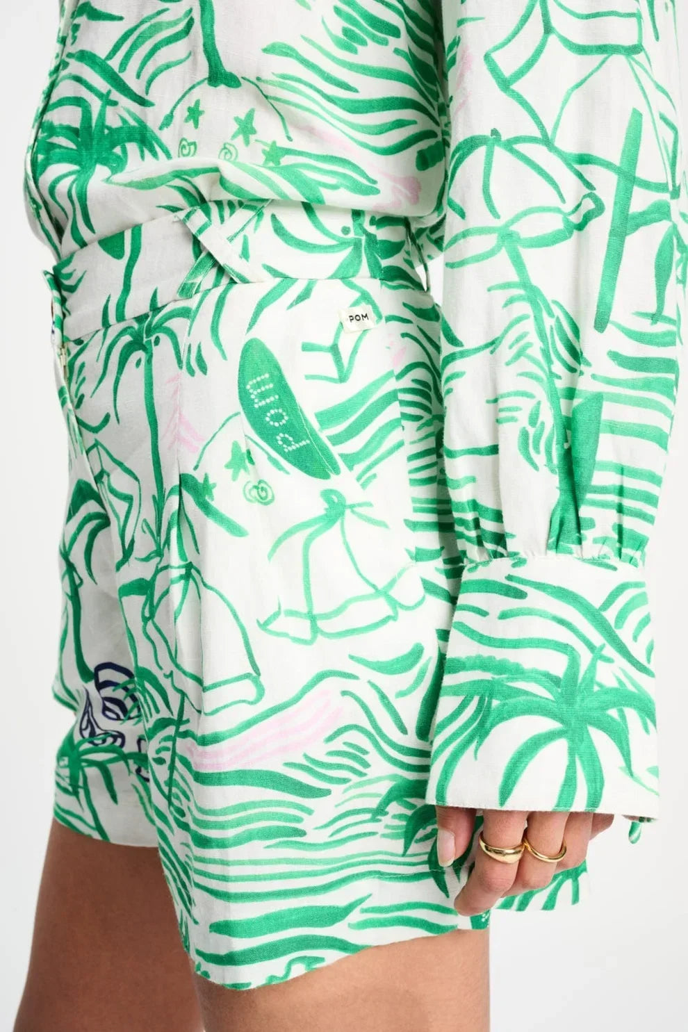 Green palm print romper with surfboard details, stylish summer outfit