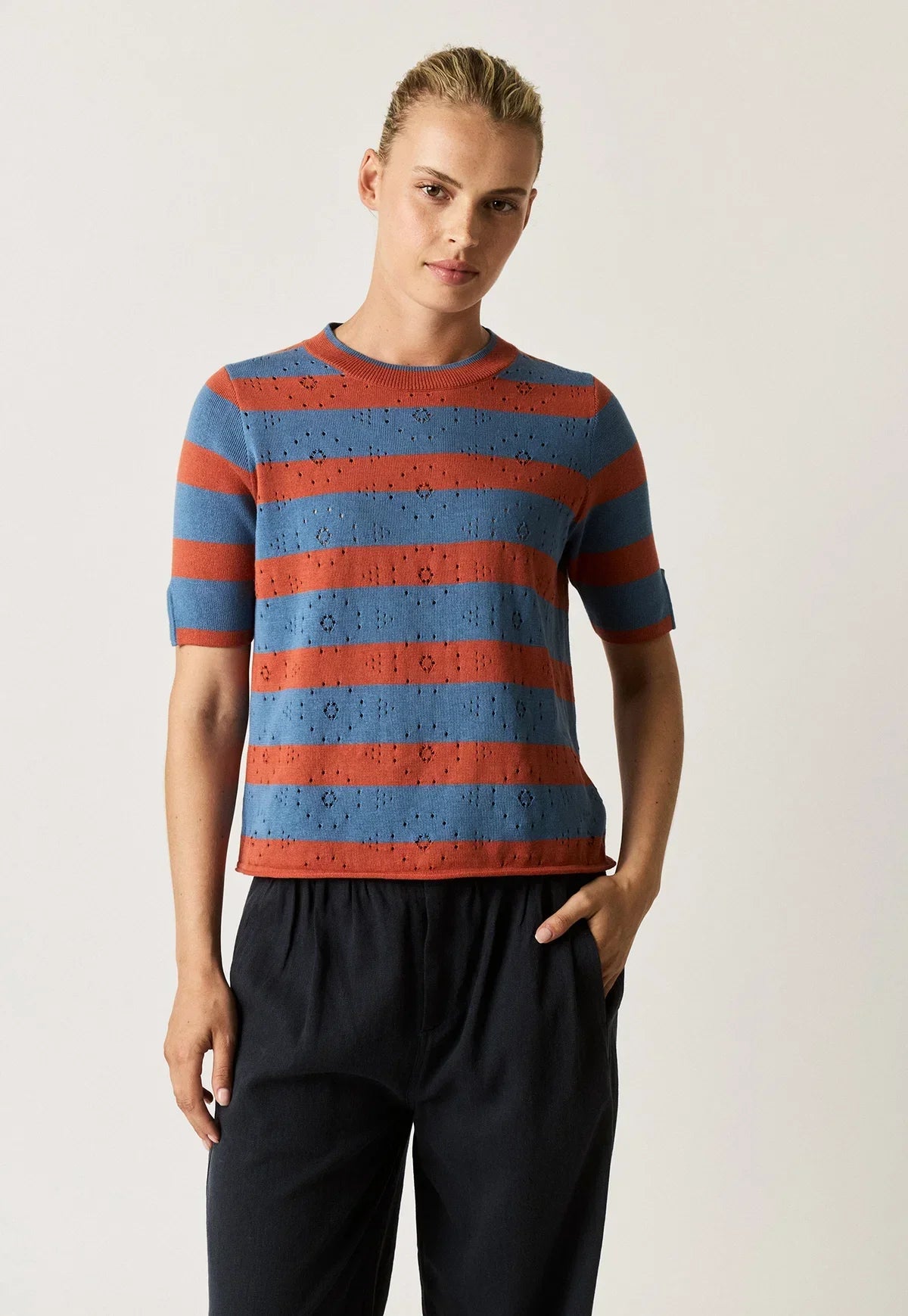 Woman wearing NANCYBIRD Rana Knit Tee in Terracotta Stripe with navy trousers