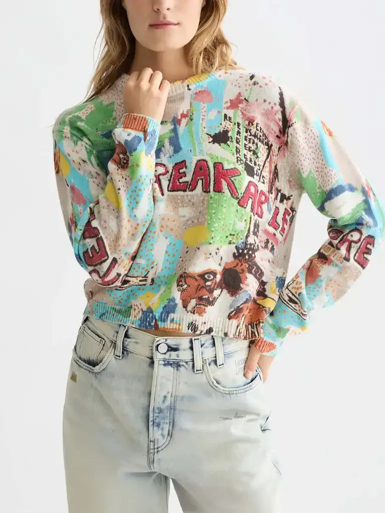 Woman wearing colorful graphic print sweater and light-wash high-waisted jeans