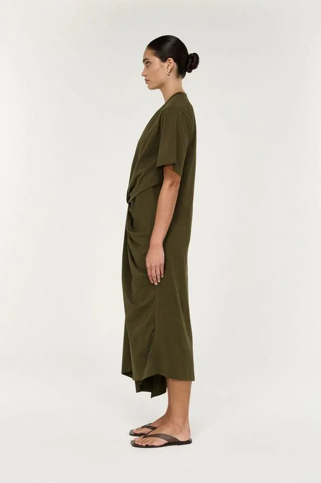 Side view of a woman wearing the STAPLE THE LABEL Tovae Draped Midi Tee Dress in olive green.