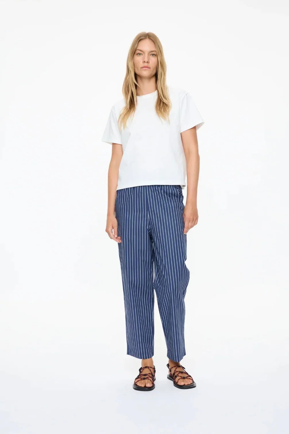 Woman wearing LMND Mimi Cropped Straight Leg Pants in blue stripes and a white t-shirt