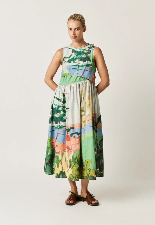 Woman wearing a NANCYBIRD Simpson Dress in Palisade with a scenic landscape print