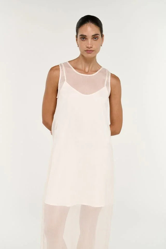 Woman wearing the STAPLE THE LABEL Aria Sheer Layered Midi Dress in cream.