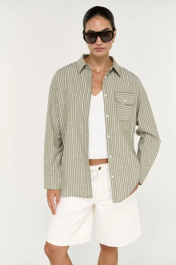 Woman wearing STAPLE THE LABEL Lisara Oversized Shirt in khaki and white stripe over white shorts