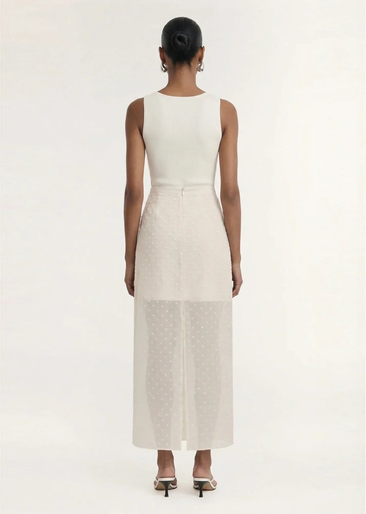 Back view of a woman wearing STAPLE THE LABEL Etoile Layered Midi Skirt in Cream Spot.