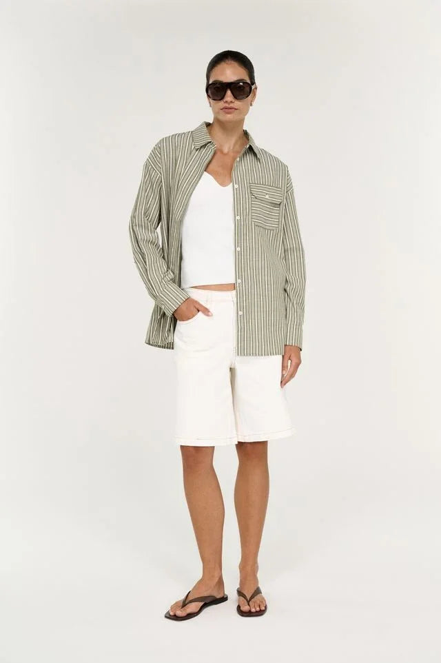Model wearing STAPLE THE LABEL Lisara Oversized Shirt in khaki and white stripe with white shorts.