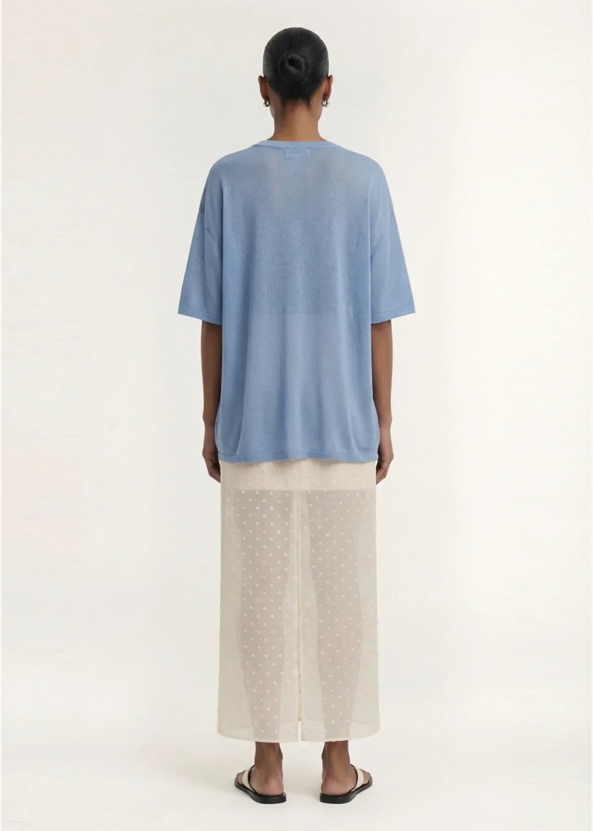 Back view of a person wearing the STAPLE THE LABEL Orla Oversized Knit Tee in Dusty Blue.