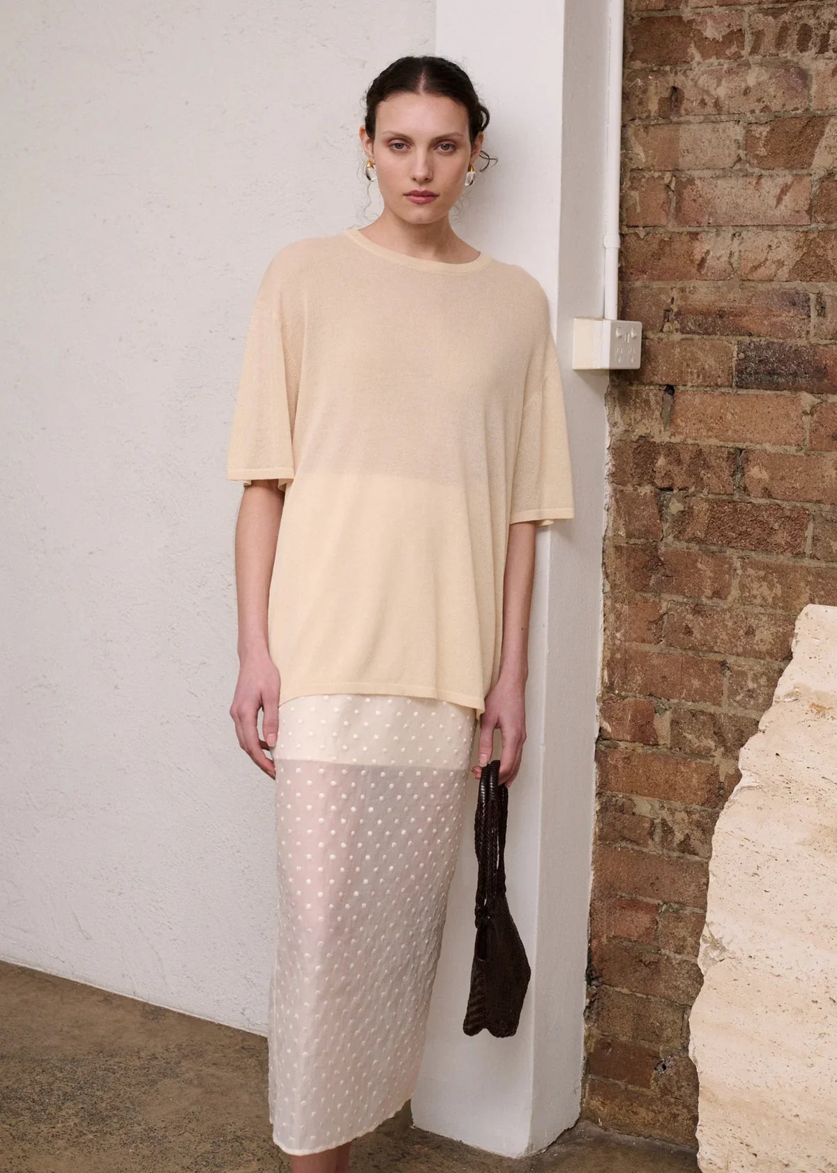 Woman wearing a STAPLE THE LABEL Etoile Layered Midi Skirt in Cream Spot and a beige top.