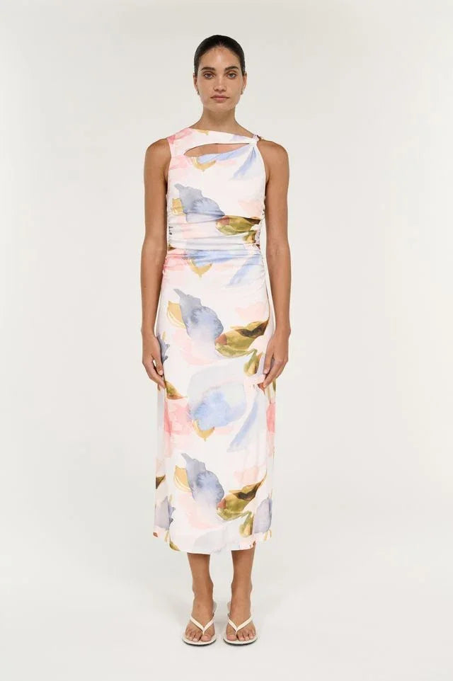 Woman wearing a white watercolor floral print midi dress with a cutout neckline.