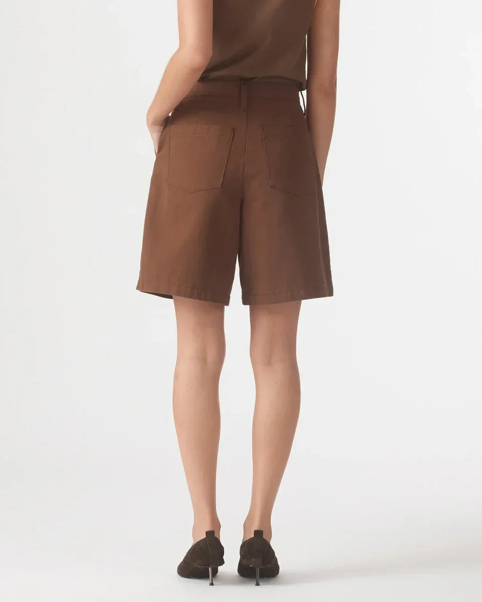 Rear view of a woman wearing Nobody Denim Rowan Bermuda Shorts in Coffee.