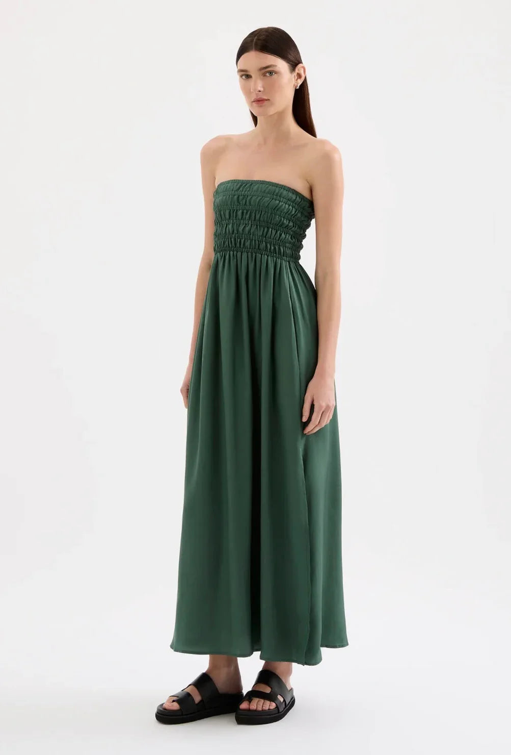 Woman modeling strapless green maxi dress with shirred bodice and black sandals