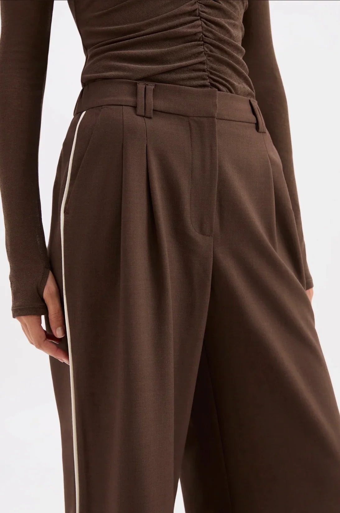 Brown wide-leg trousers with white side stripe, paired with ruched top, women's fashion