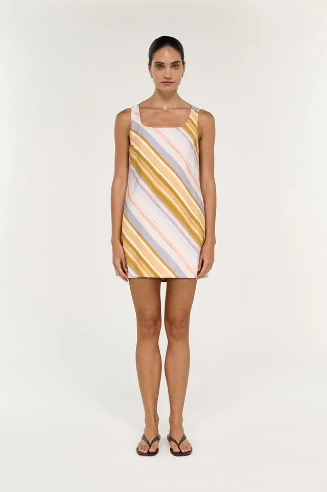 Woman wearing the STAPLE THE LABEL Veda Mini Dress in multi-colored stripes.