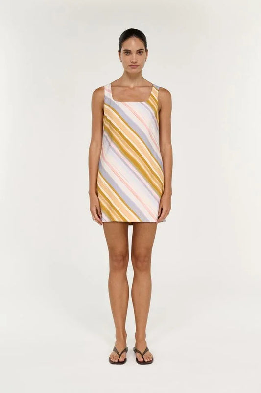 Woman wearing the STAPLE THE LABEL Veda Mini Dress in multi-colored stripes.