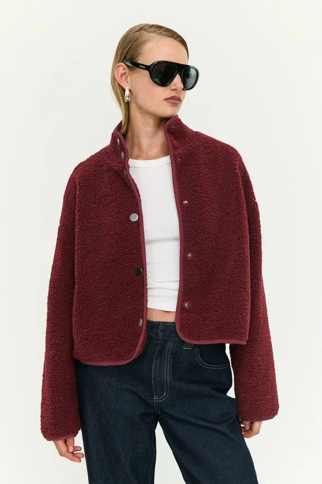 Burgundy teddy jacket with button front, styled with white top and jeans for cozy women's fashion