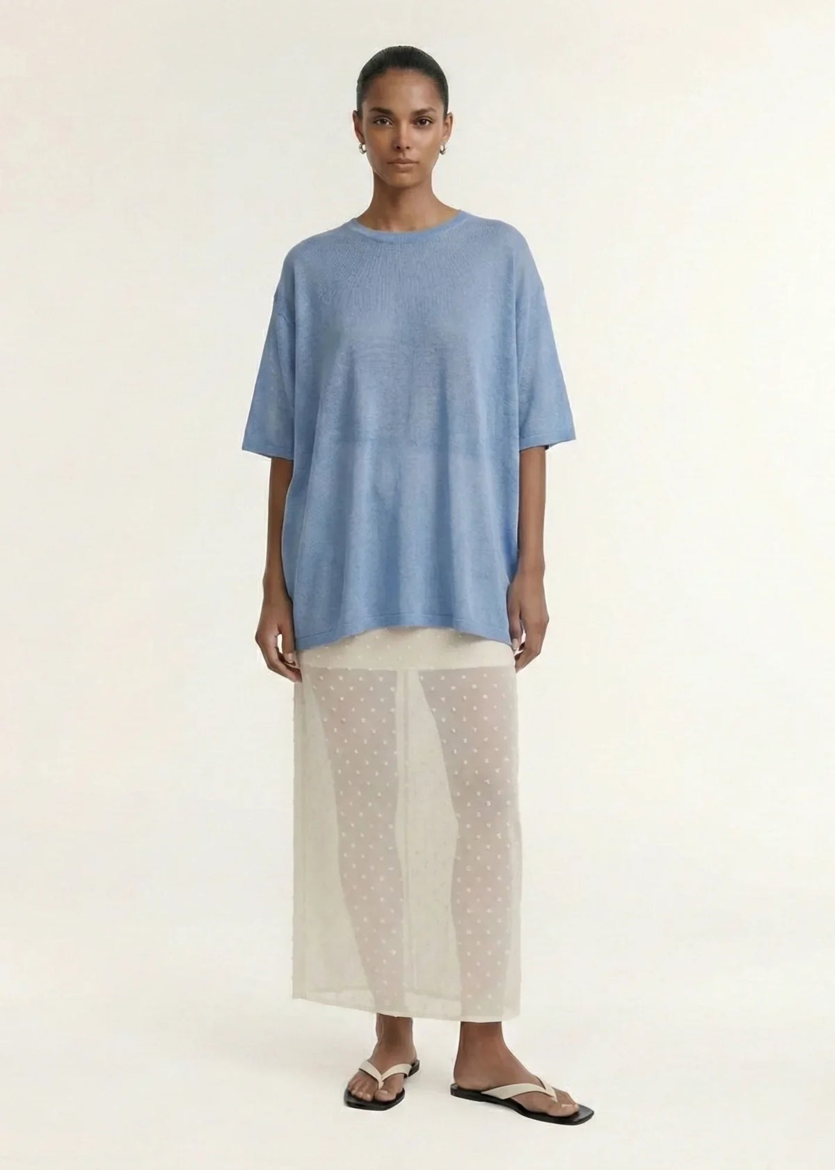 Woman wearing a blue top and STAPLE THE LABEL Etoile Layered Midi Skirt in Cream Spot