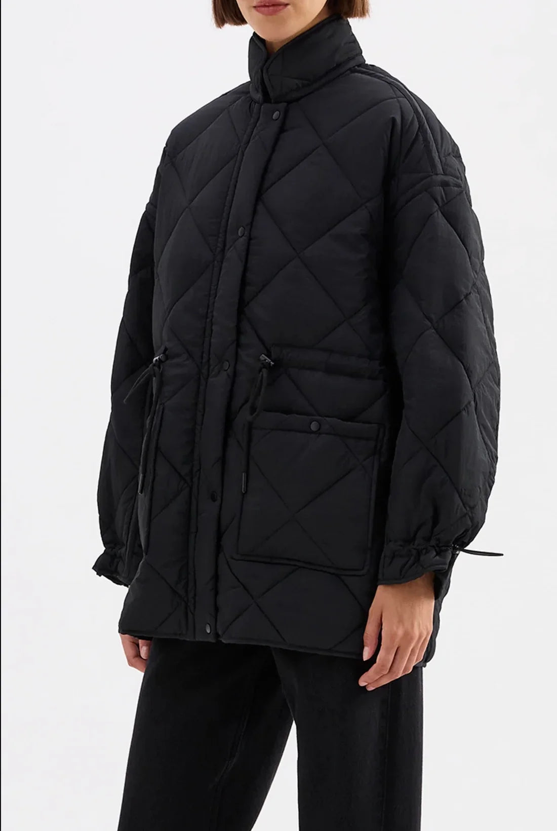 Black quilted puffer jacket with diamond stitching, front pockets, and drawstring cuffs for women's fashion