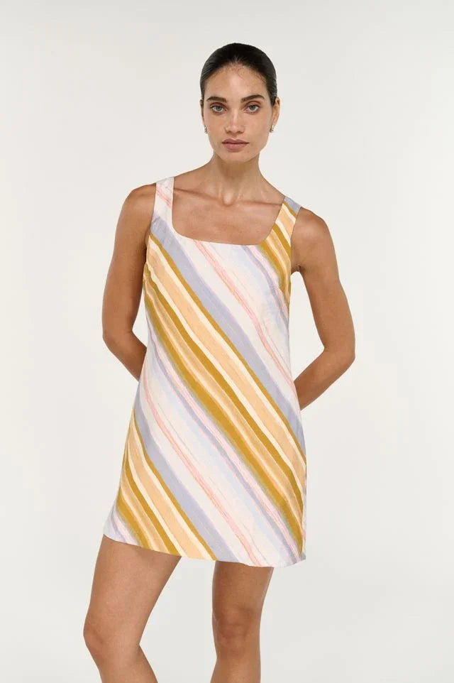 Woman wearing the STAPLE THE LABEL Veda Mini Dress in a colorful diagonal stripe pattern.