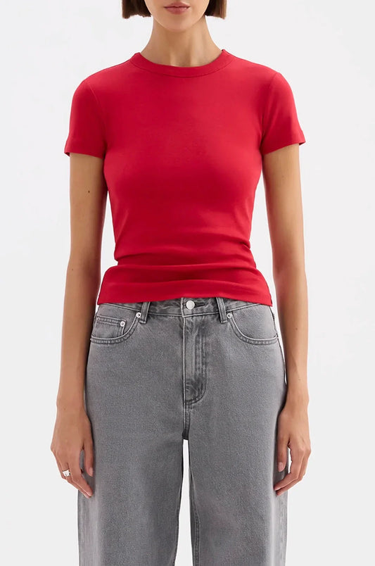Red fitted t-shirt paired with gray wide-leg jeans for women's fashion
