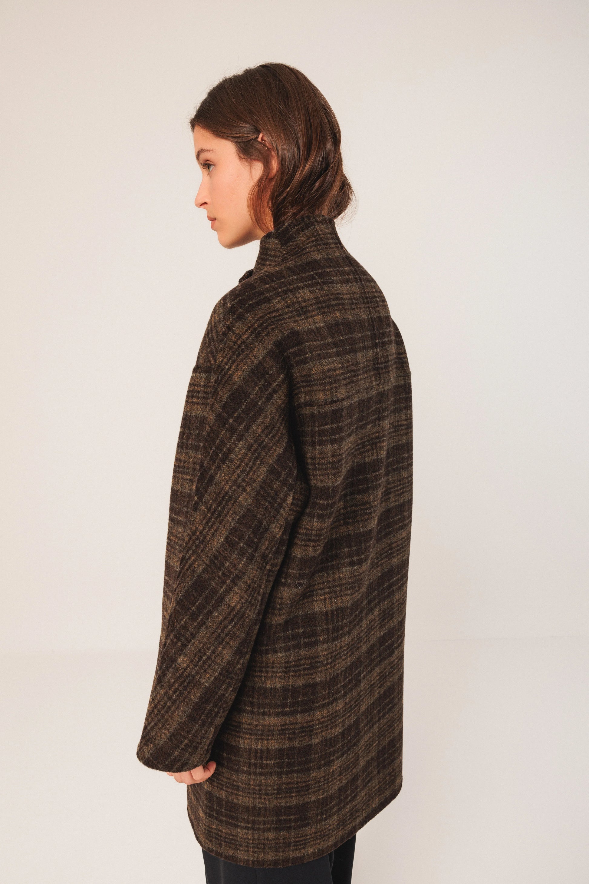 Woman in brown textured coat, side view, women's fashion