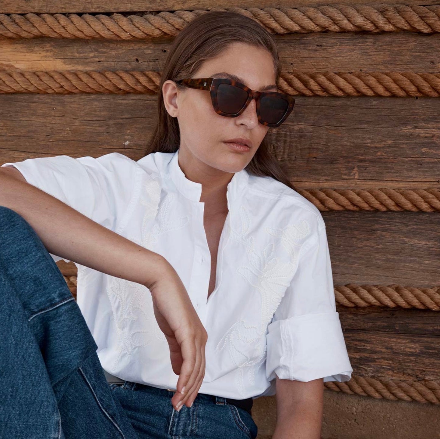 Woman in white embroidered blouse and tortoiseshell sunglasses, casual summer fashion