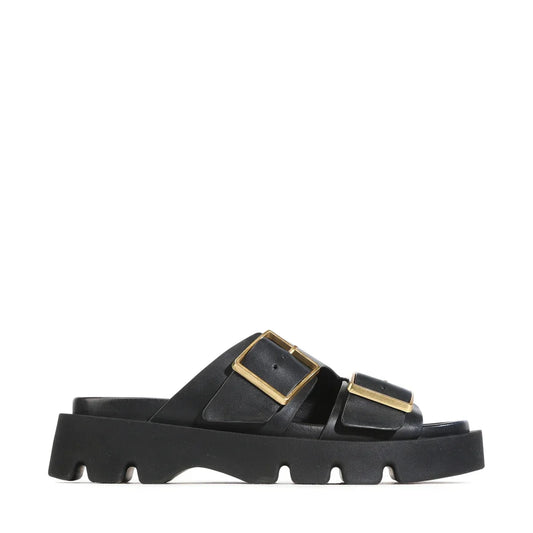 EOS Monni Slide in black leather featuring gold buckles and a chunky sole
