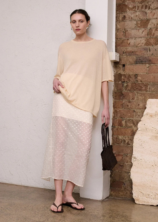 Woman wearing STAPLE THE LABEL Etoile Layered Midi Skirt in Cream Spot with a cream top.