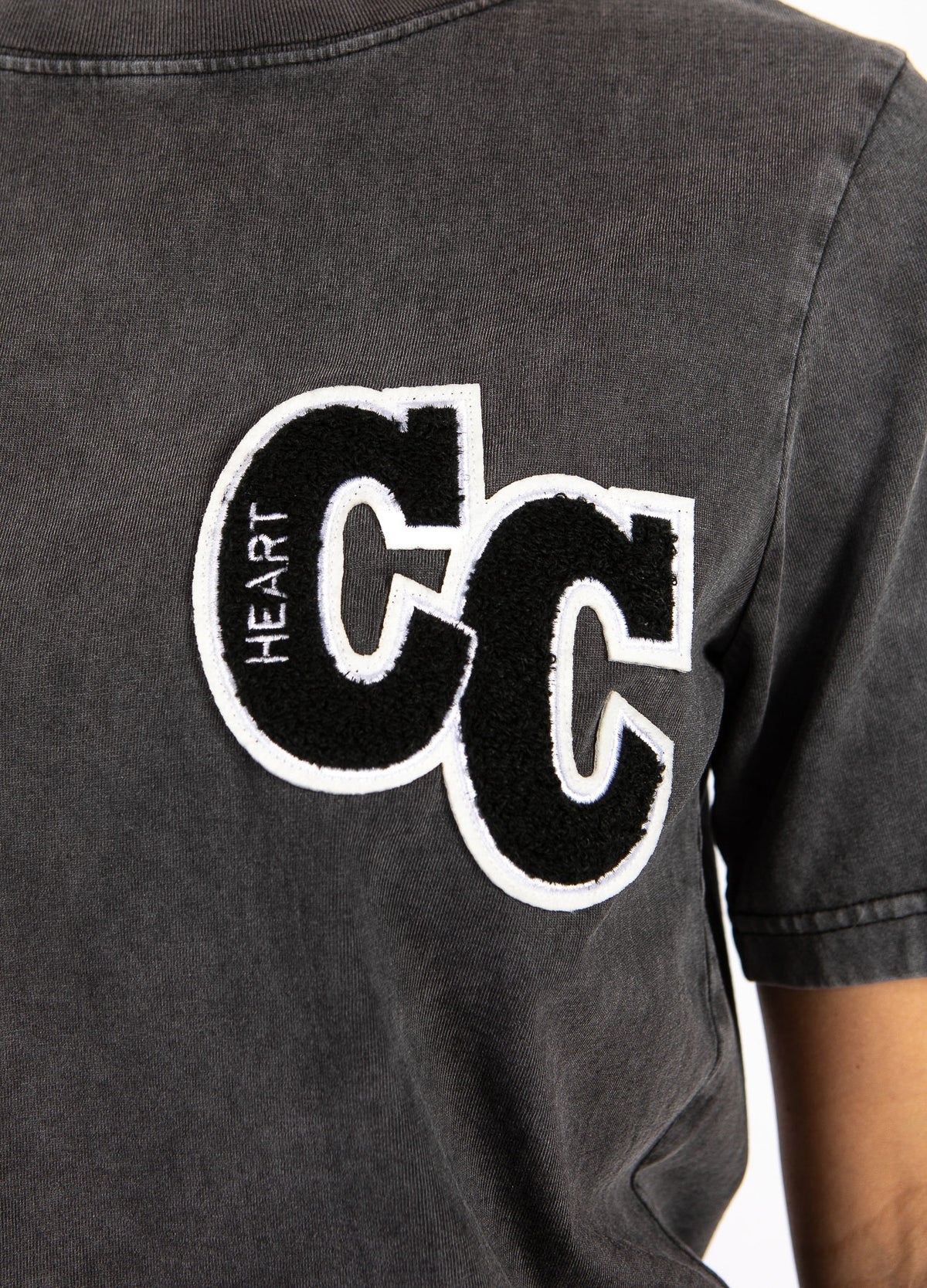 Close-up of a grey women's t-shirt with black and white 'CC HEART' patch, The Tartan Fox fashion