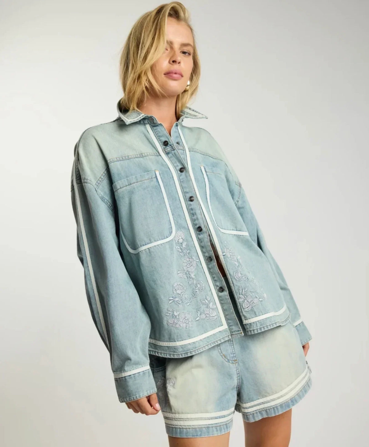 Woman wearing ONE TEASPOON Folklore Embroidered Shirt and matching denim shorts.