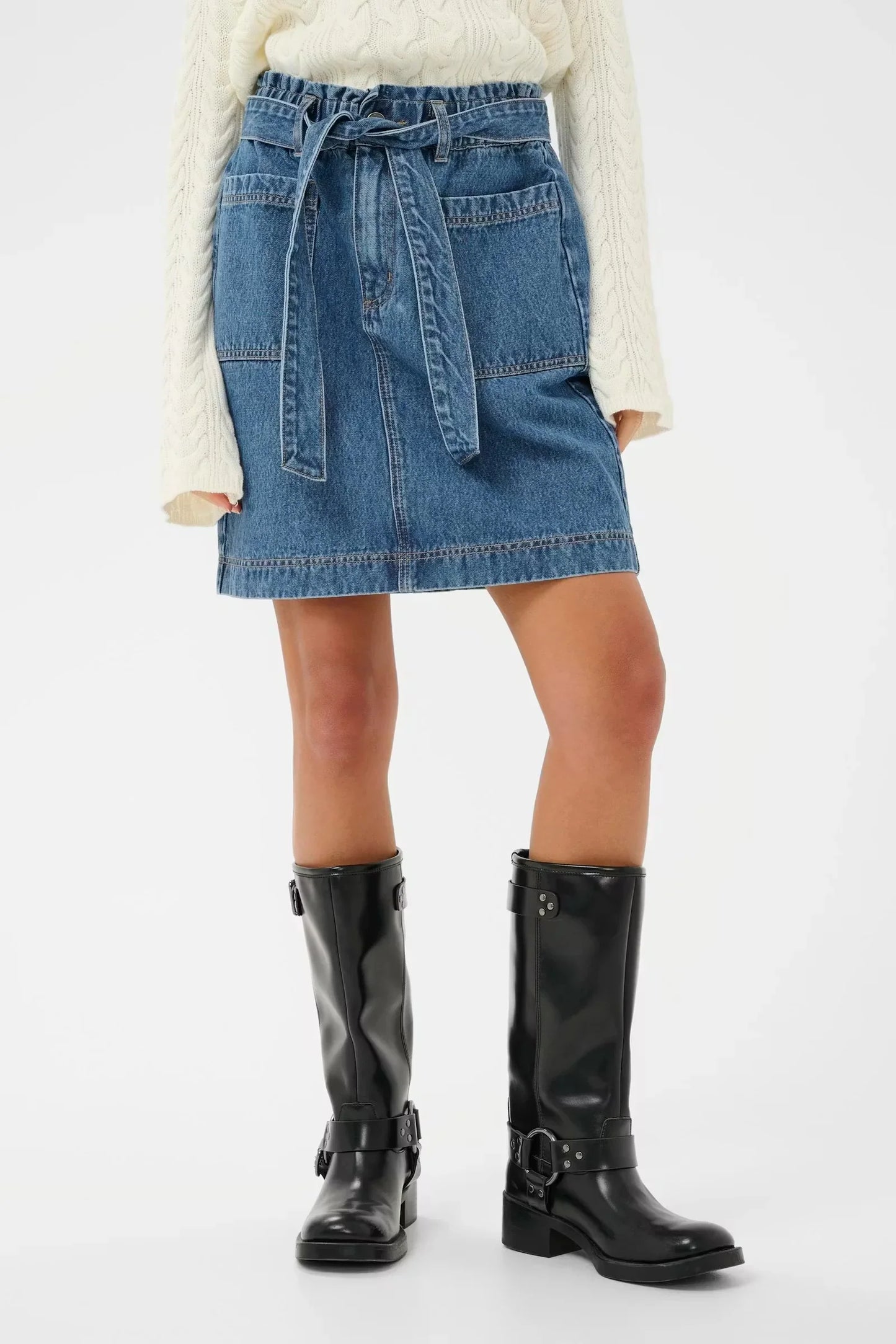 Denim skirt with tie waist, cream sweater, and black knee-high boots for women's fashion
