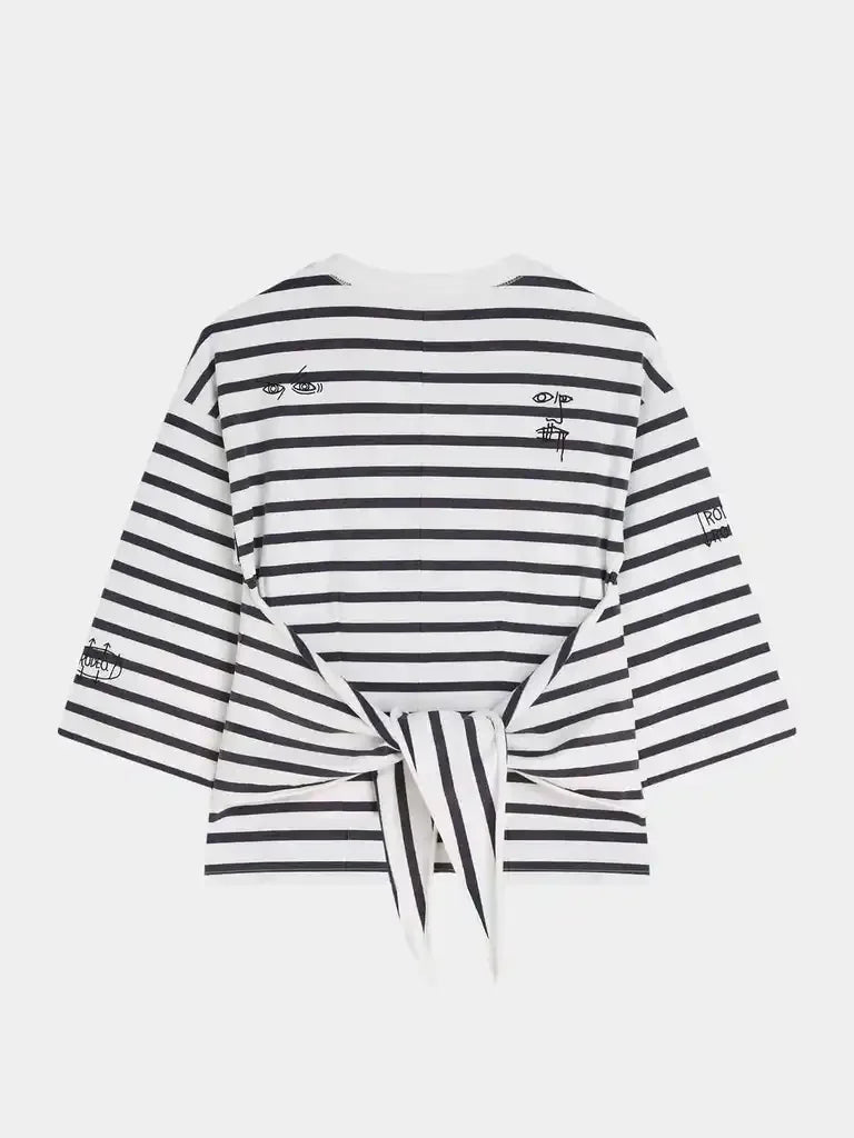 Black and white striped women's top with tie-back and graphic details